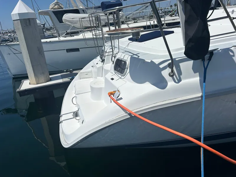 Slide: The Image of 1998 Hunter Passage 450 sailboat docked at marina with orange power cable. - 13