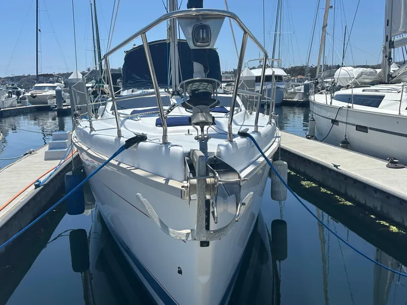 Slide: The Image of Sailboat Hunter Passage 450, 1998 model, docked at marina with clear blue sky. - 16