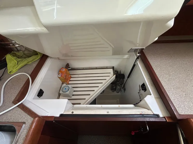 Slide: The Image of Open storage compartment in 1998 Hunter Passage 450 yacht kitchen area. - 22