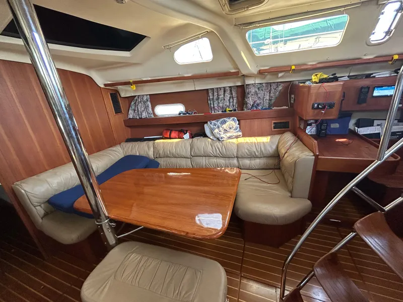 Slide: The Image of Interior of 1998 Hunter Passage 450 yacht with wooden furnishings and cozy seating area. - 26