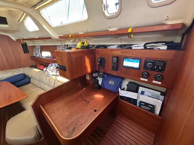 Slide: The Image of Interior of 1998 Hunter Passage 450 sailboat with navigation station and seating area. - 27
