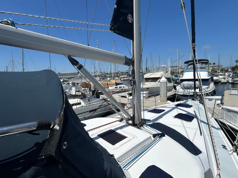 Slide: The Image of Sailboat Hunter Passage 450, 1998 model, docked in a marina under clear blue skies. - 5