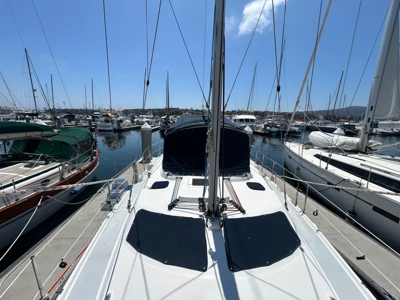 Slide: The Image of 1998 Hunter Passage 450 sailboat docked in a marina, surrounded by other boats. - 7