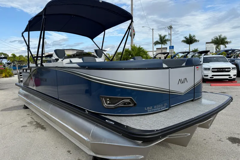 Slide: The Image of 2025 Avalon LSZ Quad Lounger 24' Tri Toon High Performance boat, docked outdoors. - 28