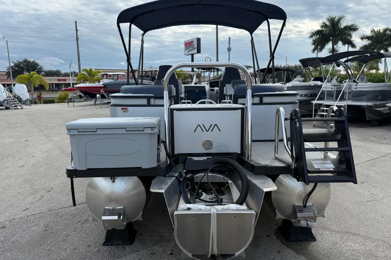 Slide: The Image of 2025 Avalon LSZ Quad Lounger 24' Tri Toon High Performance boat, rear view at marina. - 31