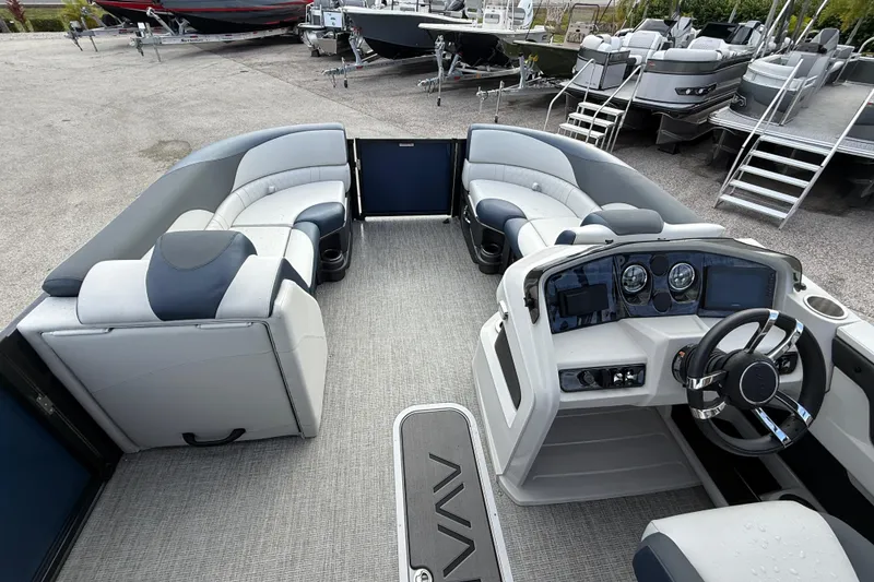 Slide: The Image of 2025 Avalon LSZ Quad Lounger 24' Tri Toon High Performance boat interior with plush seating and modern dashboard. - 38