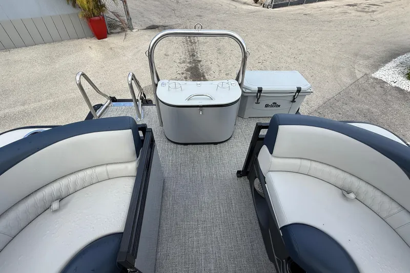 Slide: The Image of 2025 Avalon LSZ Quad Lounger boat interior with seating and storage, featuring a Grizzly cooler. - 47