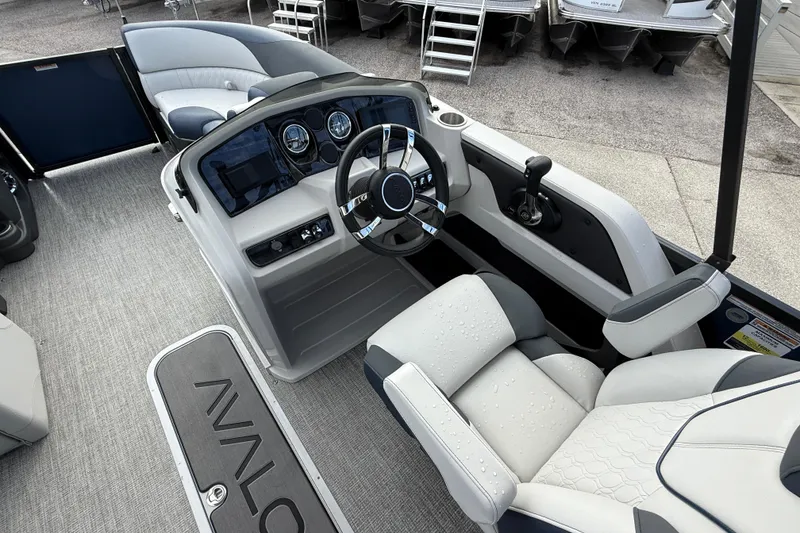 Slide: The Image of 2025 Avalon LSZ Quad Lounger boat interior with modern dashboard and comfortable seating. - 48