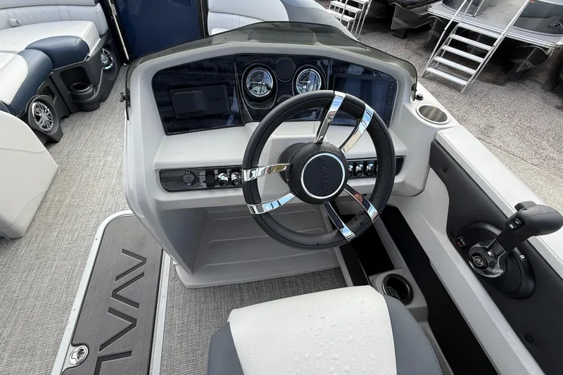 Slide: The Image of Interior view of 2025 Avalon LSZ Quad Lounger boat, featuring modern steering console and controls. - 49