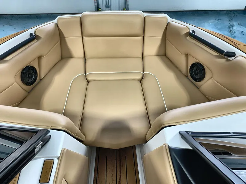 Slide: The Image of 2025 Moomba Mondo boat interior with tan leather seating and built-in speakers. - 11