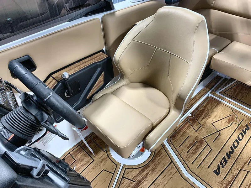 Slide: The Image of 2025 Moomba Mondo boat interior with tan seating and wood-style flooring. - 13