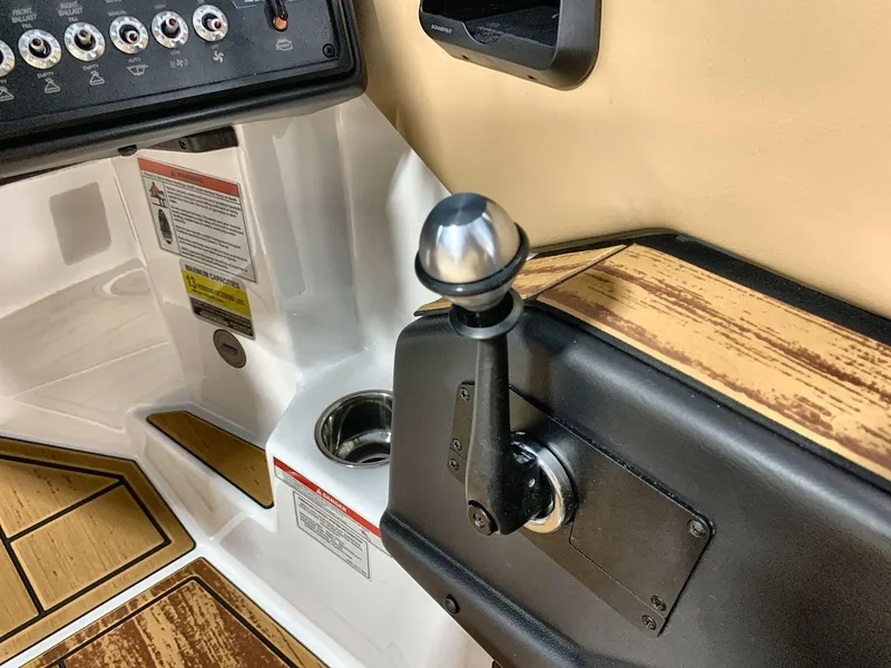 Slide: The Image of 2025 Moomba Mondo boat interior with control panel and throttle lever. - 16