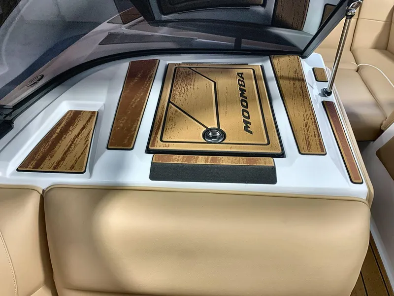 Slide: The Image of 2025 Moomba Mondo boat interior with tan upholstery and wood accents. - 18