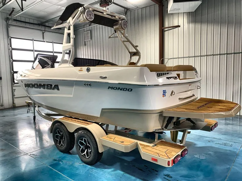 Slide: The Image of 2025 Moomba Mondo boat on trailer in a garage setting. - 3