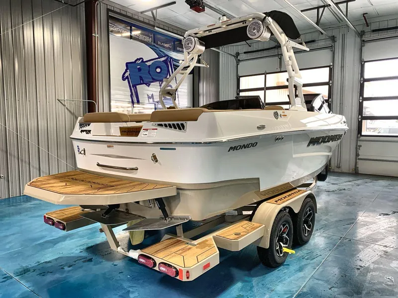 Slide: The Image of 2025 Moomba Mondo boat in showroom, featuring sleek design and modern amenities. - 5