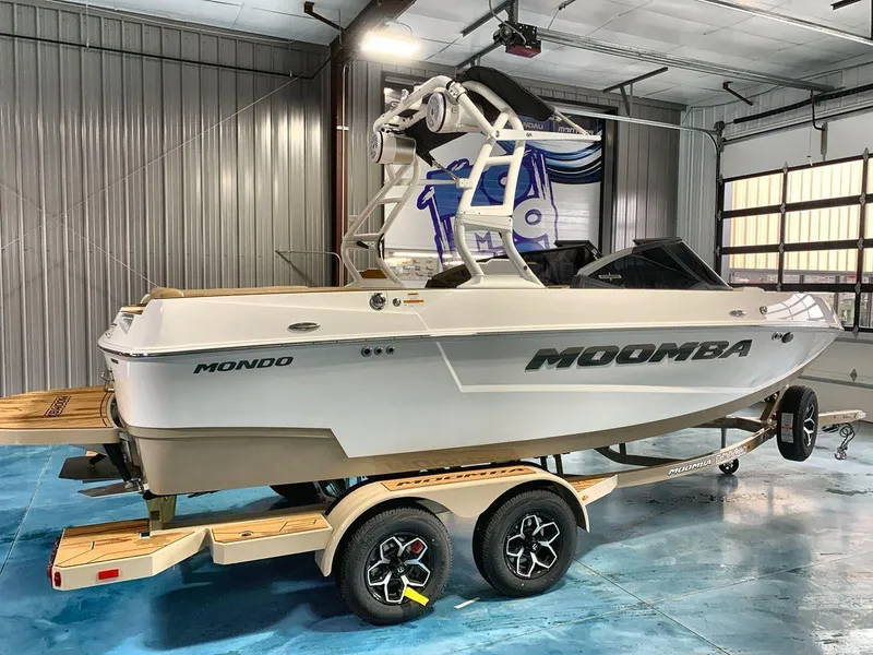 Slide: The Image of 2025 Moomba Mondo boat on trailer in indoor showroom setting. - 6