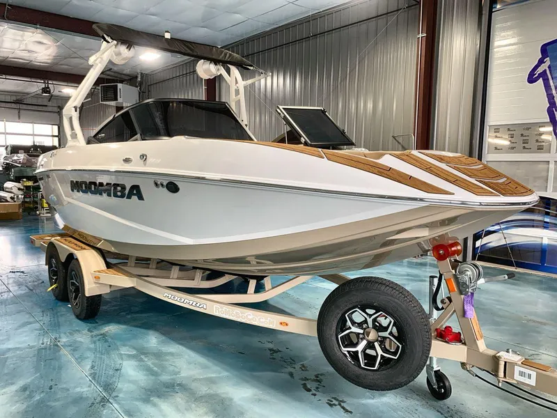 Slide: The Image of 2025 Moomba Mondo boat on trailer in indoor showroom setting. - 7