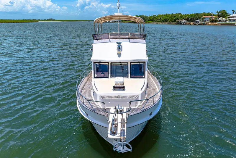 Slide: The Image of 2008 Grand Banks 47 Classic yacht on calm water, front view. - 12
