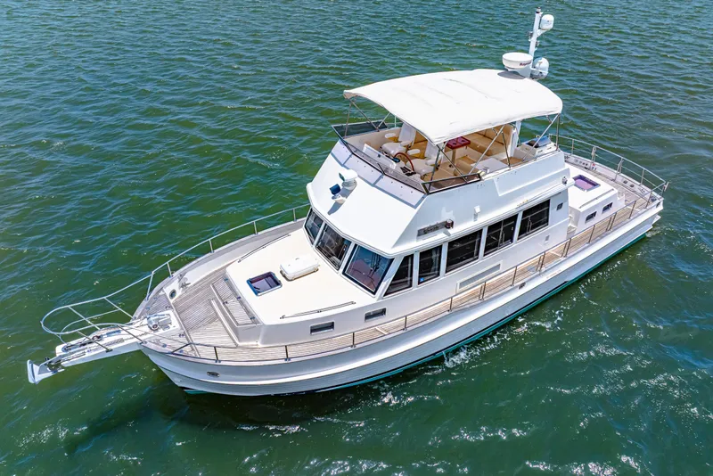 Slide: The Image of 2008 Grand Banks 47 Classic yacht cruising on open water. - 2
