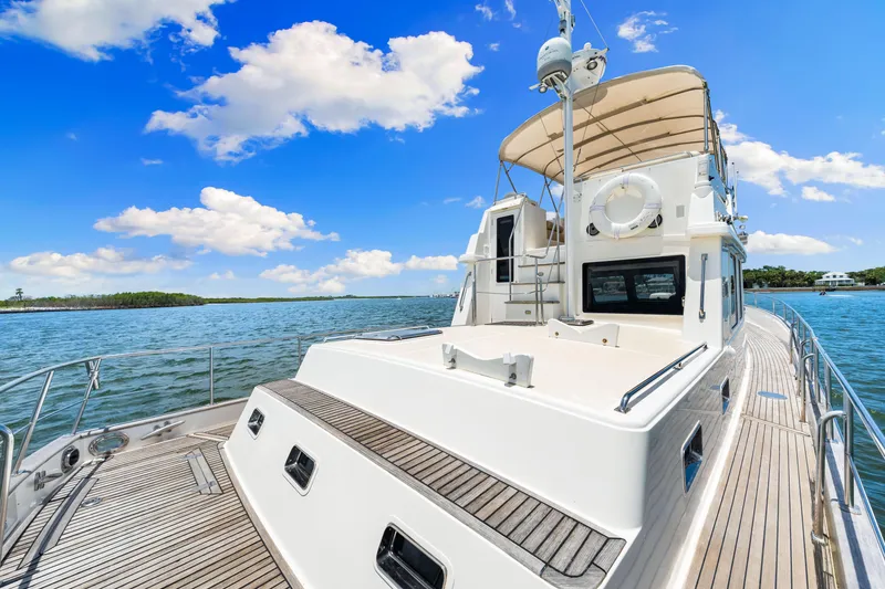 Slide: The Image of 2008 Grand Banks 47 Classic yacht on calm waters under a bright blue sky. - 21