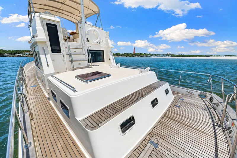 Slide: The Image of 2008 Grand Banks 47 Classic yacht on serene water with clear blue sky. - 22