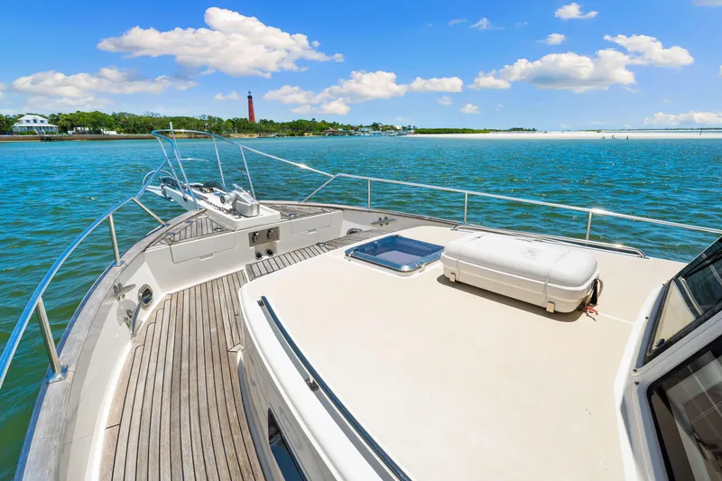 Slide: The Image of 2008 Grand Banks 47 Classic yacht cruising on a sunny day with scenic coastal view. - 26
