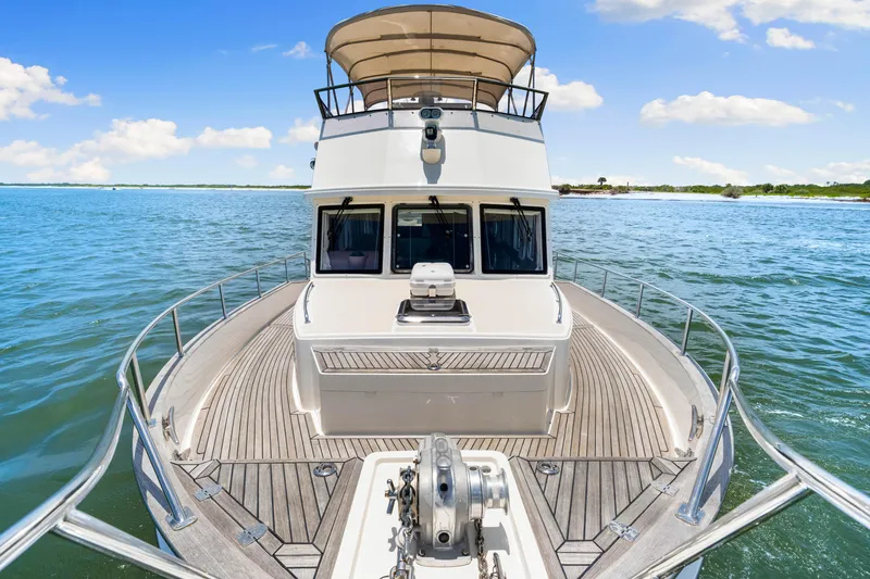 Slide: The Image of 2008 Grand Banks 47 Classic yacht on calm waters under a clear blue sky. - 29