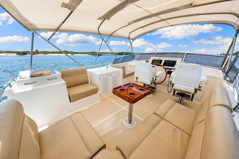 Slide: The Image of 2008 Grand Banks 47 Classic yacht interior with seating and helm, cruising on open water. - 33
