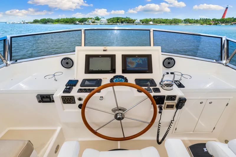 Slide: The Image of Helm of 2008 Grand Banks 47 Classic yacht with navigation equipment and scenic water view. - 36