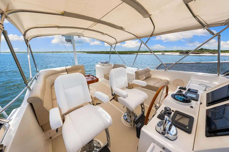 Slide: The Image of Luxurious 2008 Grand Banks 47 Classic yacht interior with helm, seating, and ocean view. - 37