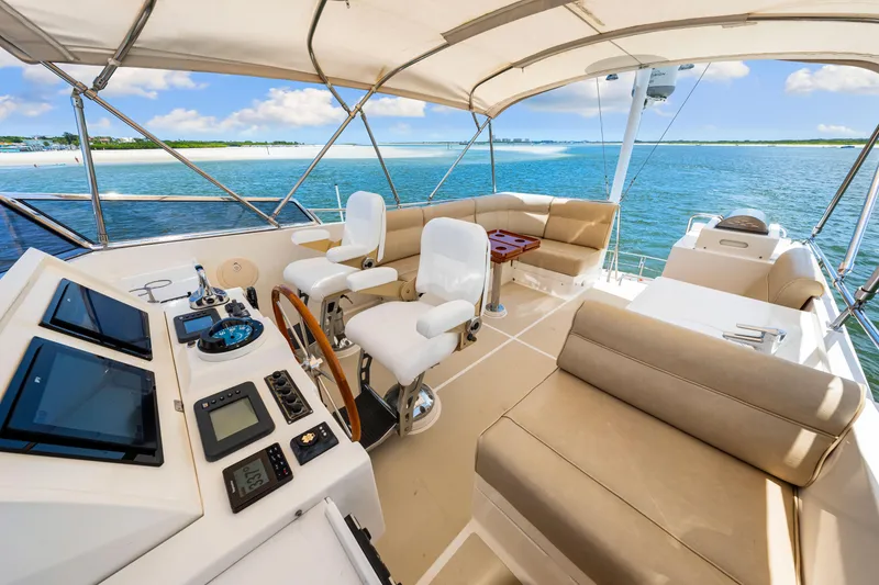 Slide: The Image of Luxurious 2008 Grand Banks 47 Classic yacht interior with helm, seating, and ocean view. - 38