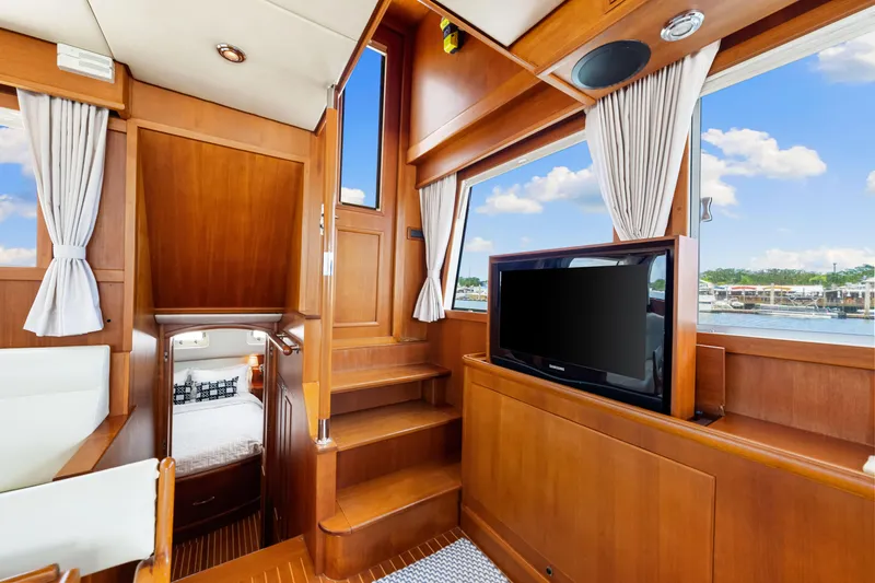 Slide: The Image of Luxurious interior of 2008 Grand Banks 47 Classic yacht with wood finish and TV. - 44