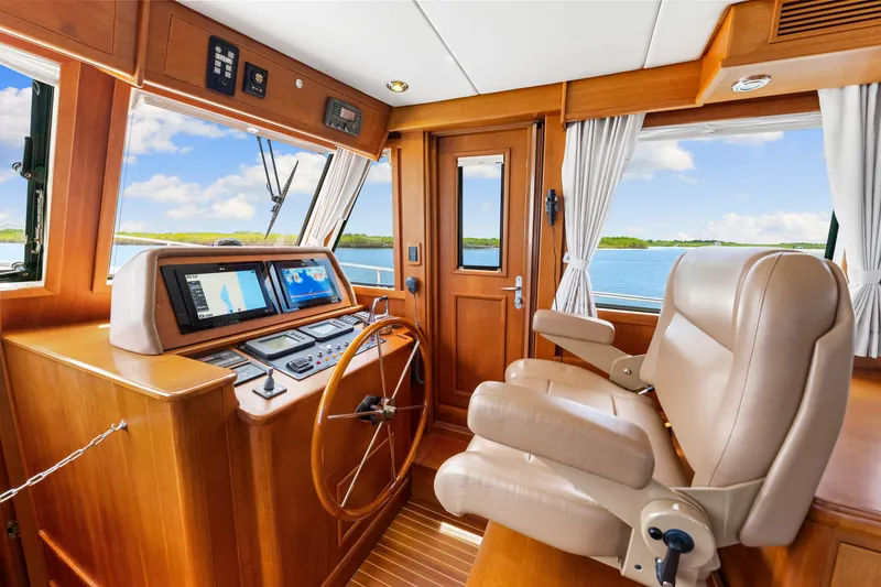 Slide: The Image of Pilothouse of 2008 Grand Banks 47 Classic yacht with leather seating and navigation equipment. - 46