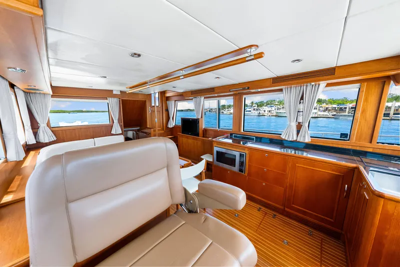 Slide: The Image of Luxurious interior of 2008 Grand Banks 47 Classic yacht with wood finish and waterfront view. - 49