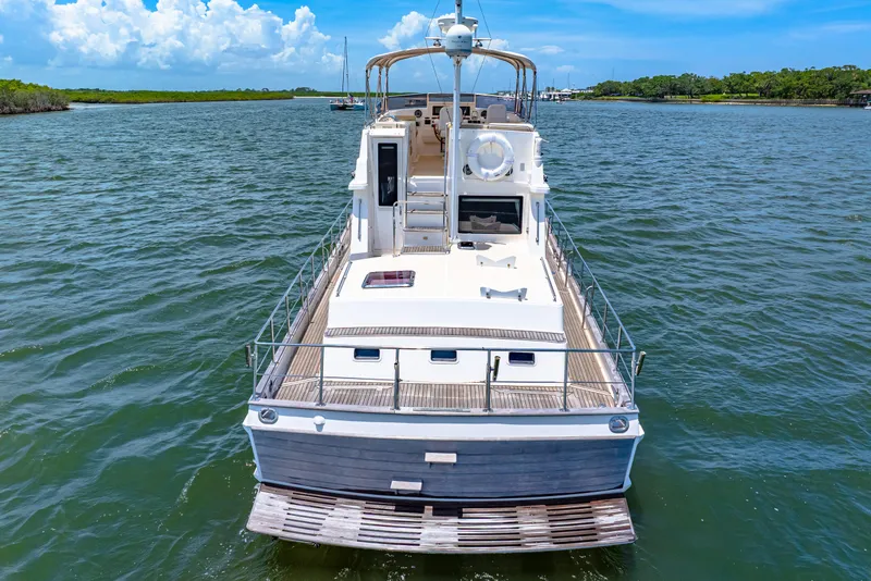 Slide: The Image of 2008 Grand Banks 47 Classic yacht on calm water, showcasing elegant design and spacious deck. - 8