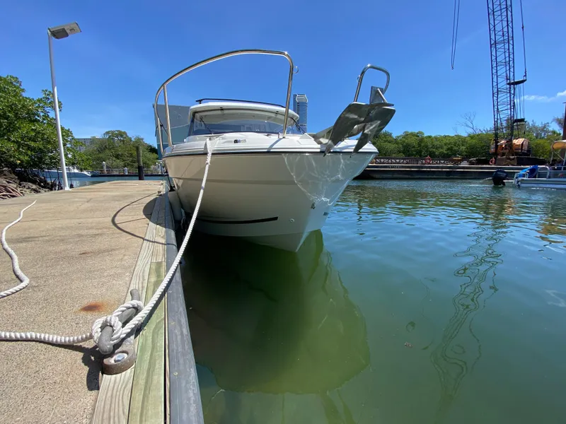 Slide: The Image of 2023 Jeanneau NC Weekender 795 Series 2 docked in a marina under clear blue skies. - 12