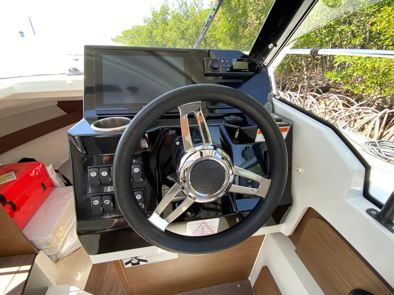 Slide: The Image of 2023 Jeanneau NC Weekender 795 Series 2 helm with modern steering and controls. - 16