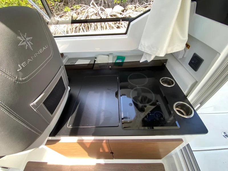 Slide: The Image of Interior of 2023 Jeanneau NC Weekender 795 Series 2, featuring a modern kitchenette. - 17