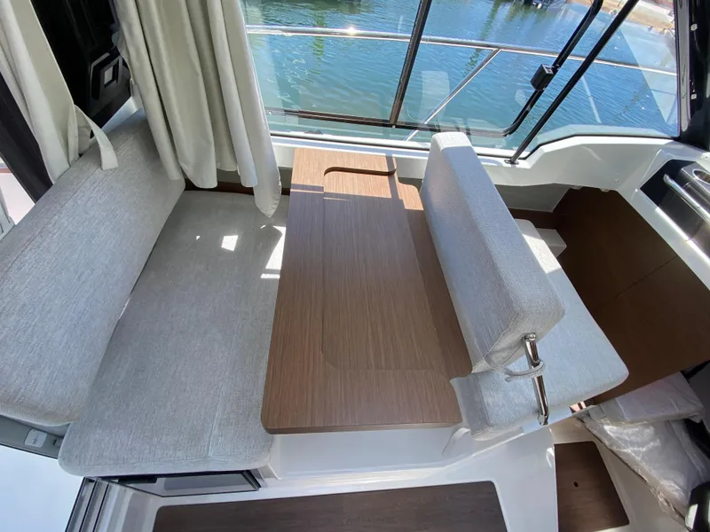Slide: The Image of Interior of 2023 Jeanneau NC Weekender 795 Series 2, featuring a cozy seating area. - 18
