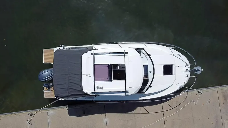 Slide: The Image of Overhead view of 2023 Jeanneau NC Weekender 795 Series 2 docked at marina. - 23
