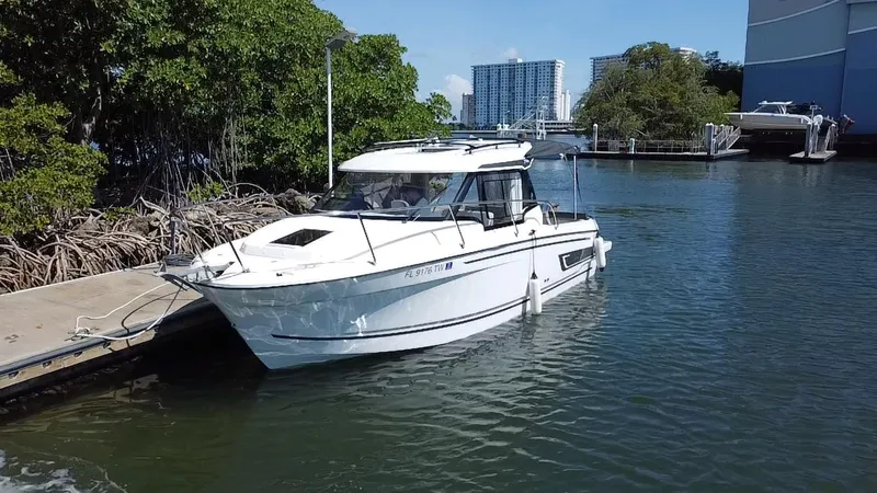 Slide: The Image of 2023 Jeanneau NC Weekender 795 Series 2 docked in a scenic marina setting. - 3
