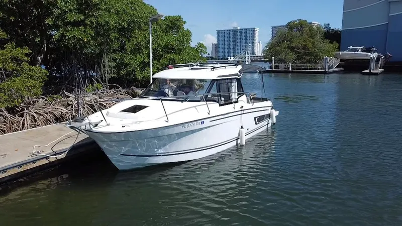Slide: The Image of 2023 Jeanneau NC Weekender 795 Series 2 docked in a scenic marina setting. - 4
