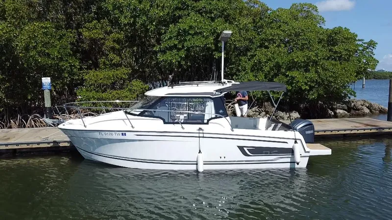 Slide: The Image of 2023 Jeanneau NC Weekender 795 Series 2 docked by lush greenery. - 7