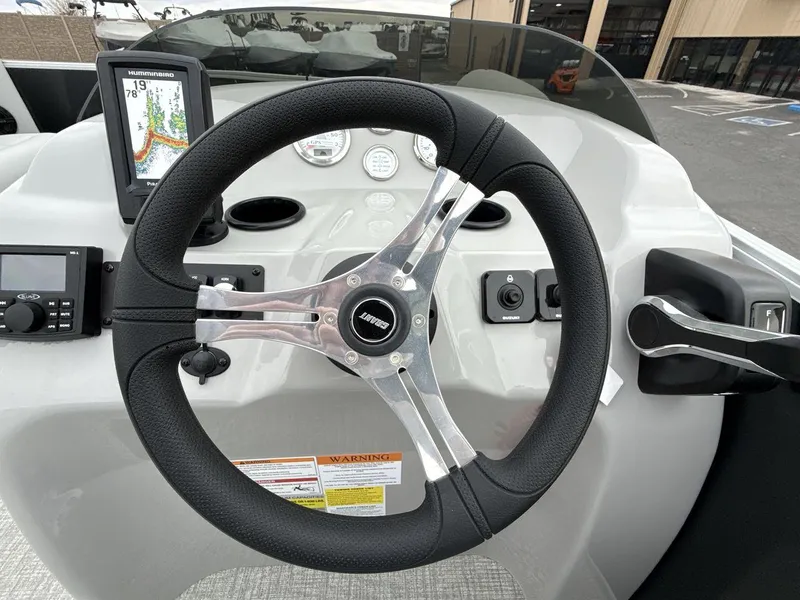 Slide: The Image of Steering console of 2025 Landau Island Breeze 19 C boat with navigation display. - 14