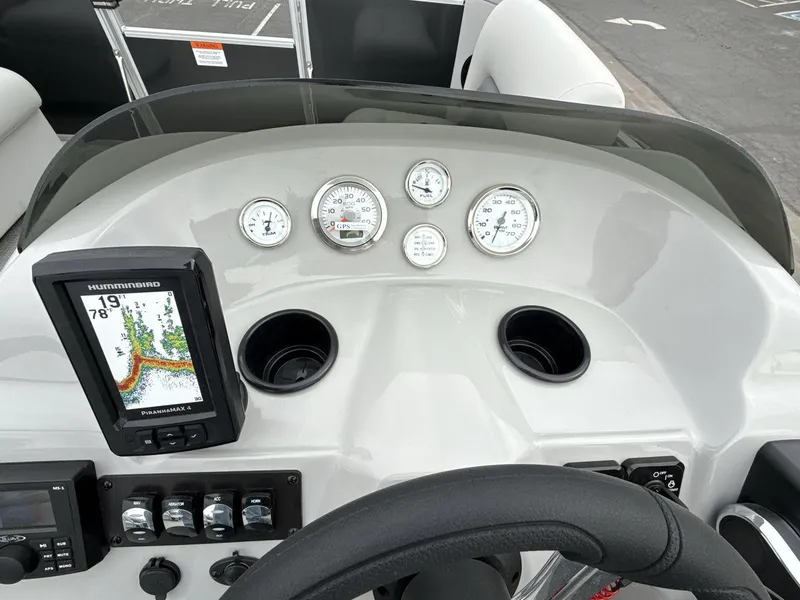 Slide: The Image of Dashboard of 2025 Landau Island Breeze 19 C with gauges and Humminbird fish finder. - 18