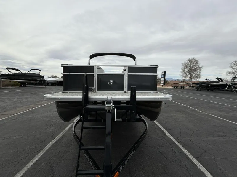 Slide: The Image of 2025 Landau Island Breeze 19 C pontoon boat on trailer in parking lot. - 8