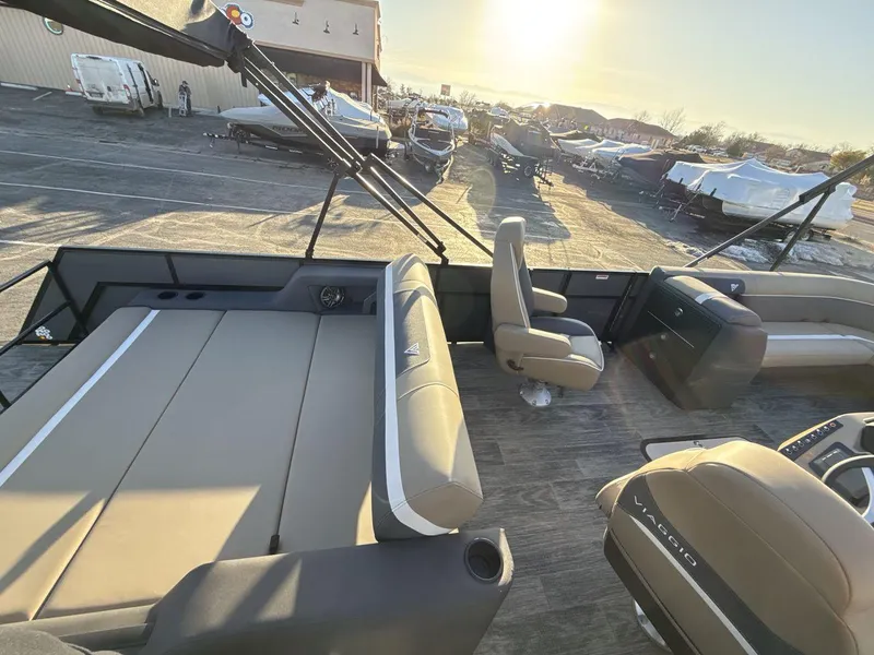 Slide: The Image of 2025 Viaggio x24s boat interior with seating and helm, parked outdoors under sunlight. - 10