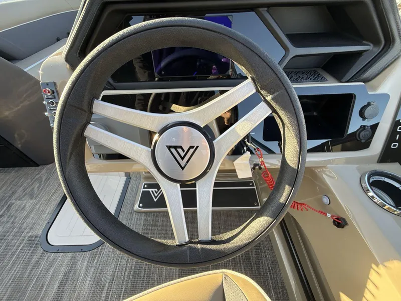 Slide: The Image of Steering wheel of 2025 Viaggio x24s boat, featuring modern dashboard design. - 14