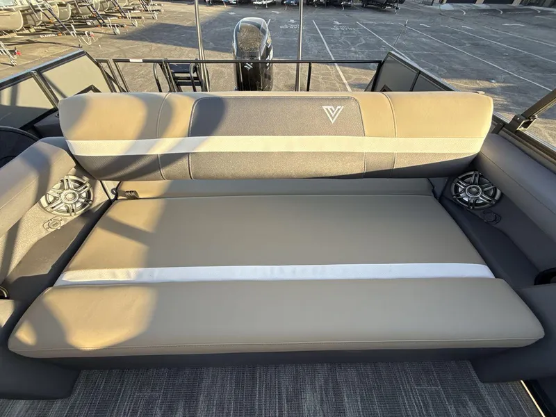 Slide: The Image of 2025 Viaggio x24s boat interior with beige seating and built-in speakers. - 19