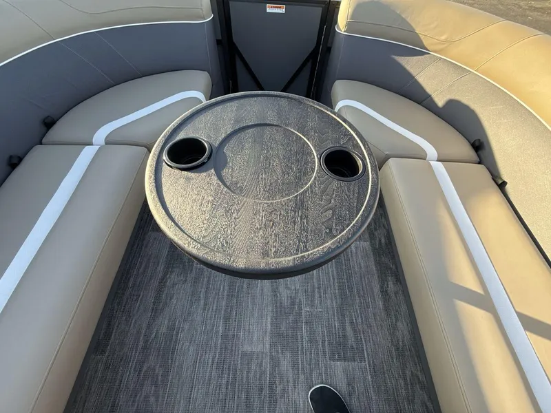 Slide: The Image of 2025 Viaggio x24s interior with round table and cup holders, featuring beige seating. - 21